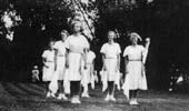 Morris dancing girls on tennis courts.